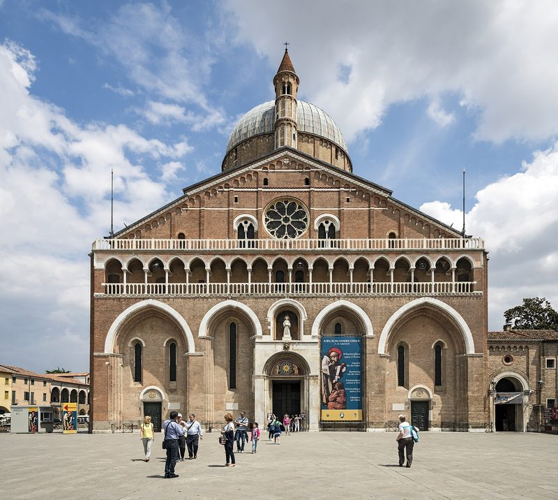 The Basilica of St. Anthony in Padua: a brick façade crowned with domes and slender towers.