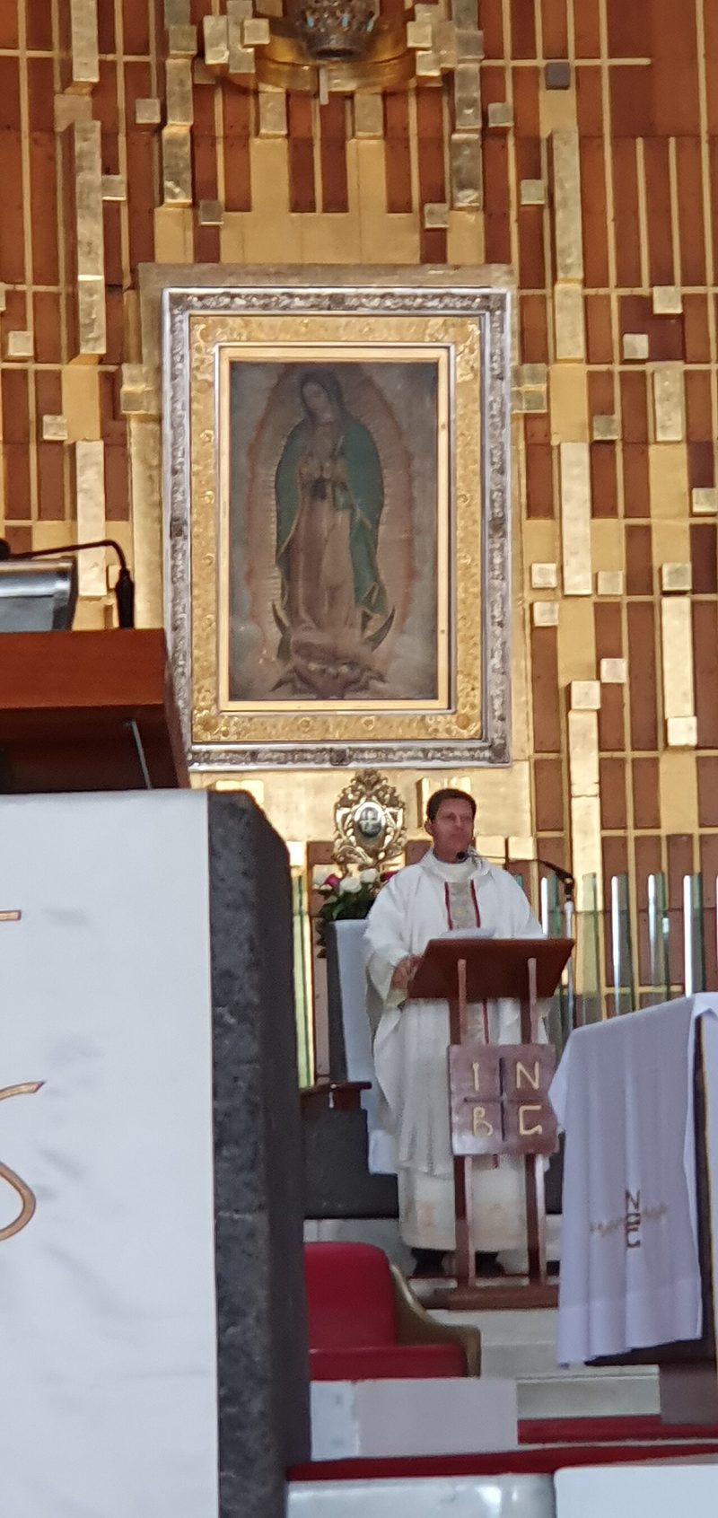 The main altar of the Basilica of Our Lady of Guadalupe in Mexico City, with the image on the tilma framed in gold.