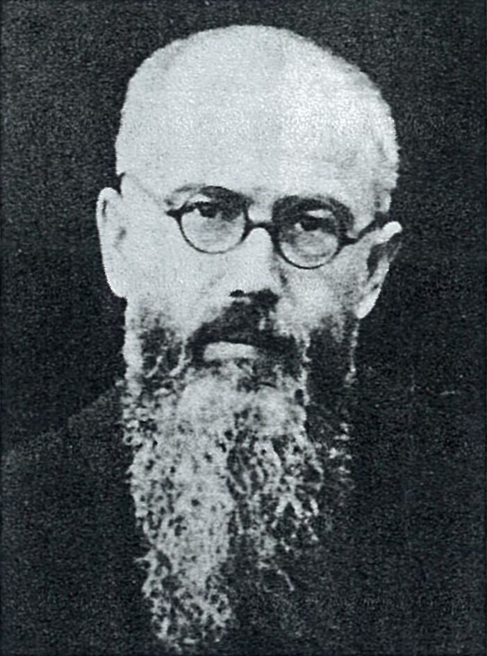 A photograph of Fr Maximilian Kolbe in 1936: a Franciscan priest with round glasses and a long beard.