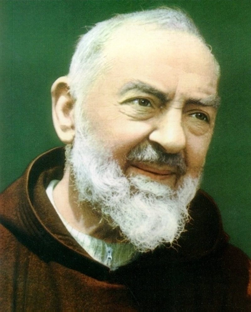 A color portrait of Padre Pio: an elderly Capuchin friar with a white beard and a warm, steady gaze.
