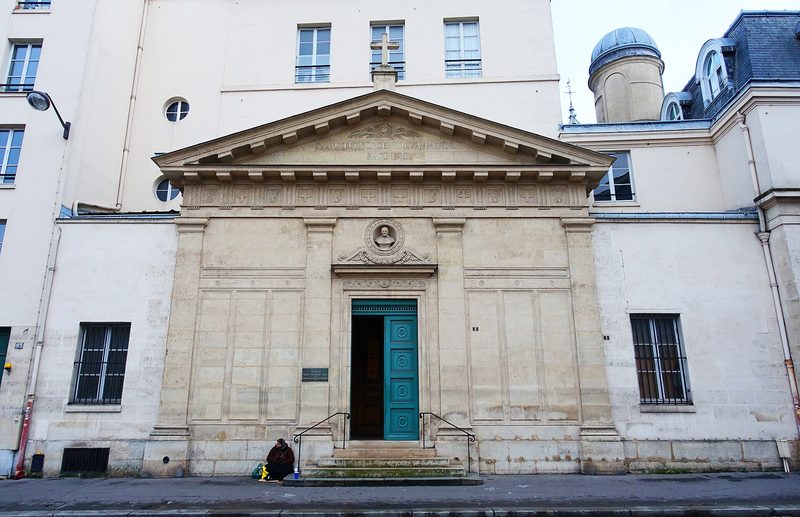 The Chapel of St. Vincent de Paul in Paris: a pale neoclassical façade with columns and a pediment on a city street.