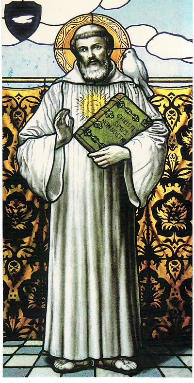 Stained-glass window of St. Columban in a white habit, holding a book.