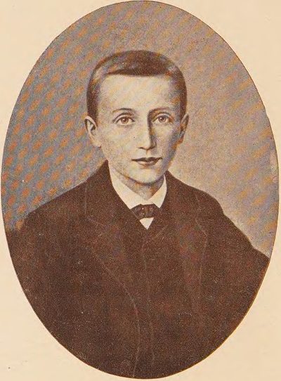 Oval portrait of St. Dominic Savio as a boy in a dark jacket.