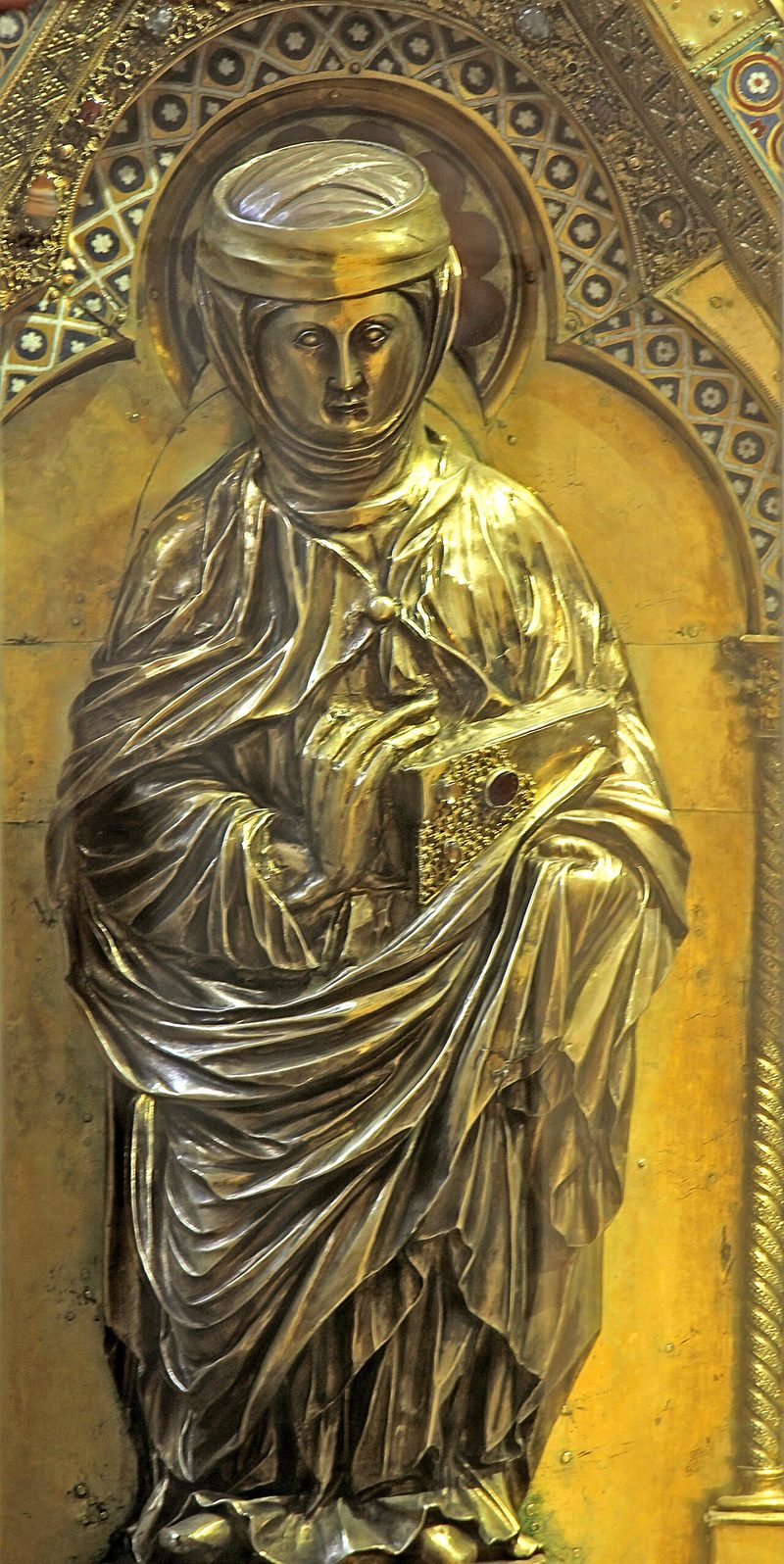 Gilded relief of St. Elizabeth of Hungary standing in a long robe and veil.