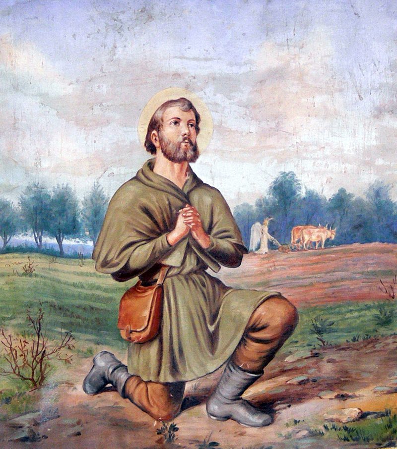 Painting of St. Isidore the Farmer kneeling in prayer in a field, oxen plowing behind him.