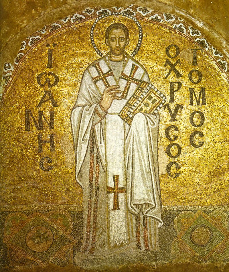 Mosaic of St. John Chrysostom in white bishop’s vestments on a gold background, holding a book.