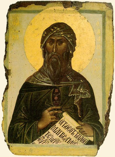Icon of St. John Damascene in a dark turban and robe, holding a scroll with writing.
