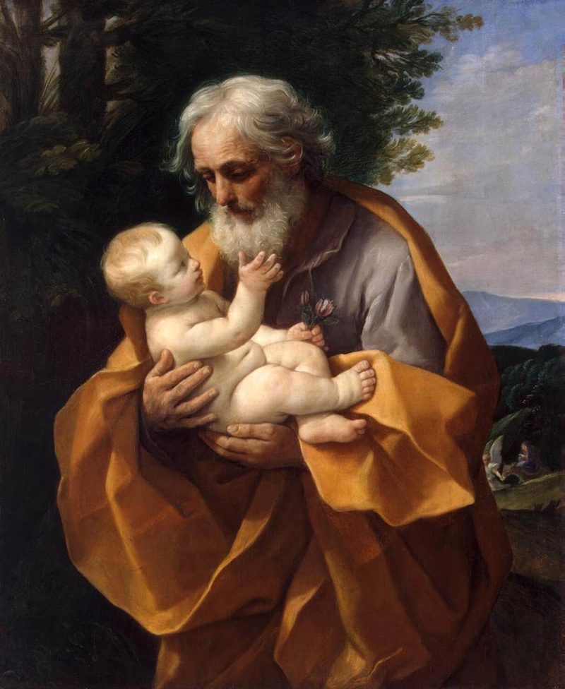 Painting of St. Joseph, white-bearded, holding the infant Jesus in his arms.
