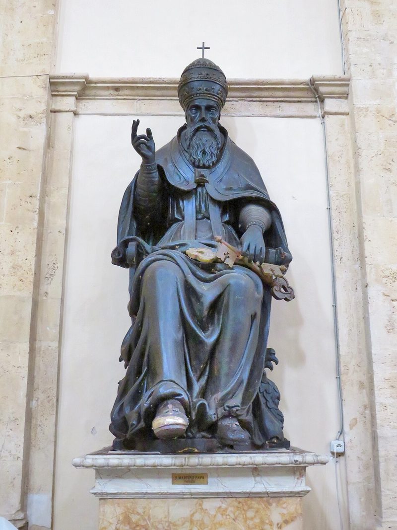 Bronze statue of Pope St. Martin I seated, raising his hand in blessing.