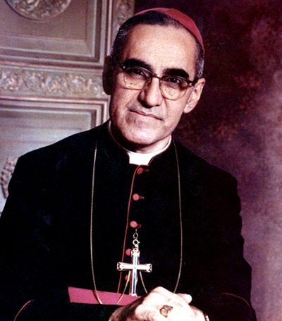 Photograph of St. Oscar Romero in glasses and a bishop’s cassock with a pectoral cross.