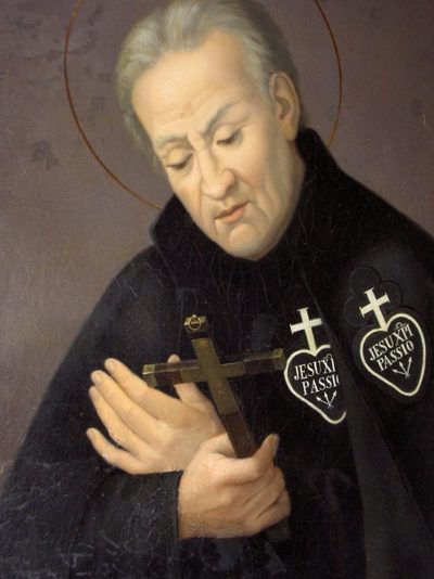 Painting of St. Paul of the Cross in a black habit with the Passionist badge, holding a crucifix.